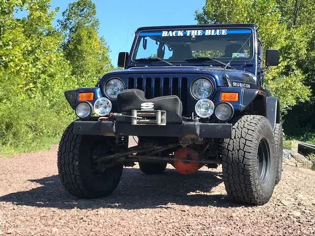 ’03 TJ Rubicon 2 dr, Patriot blue, 5 speed short shift, 33 ProComps, full hard doors, Bestop, all options